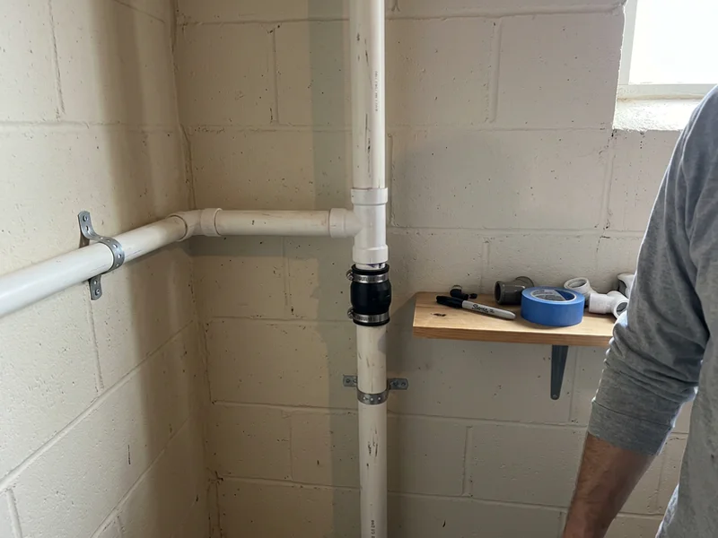 Auxiliary discharge line and separate check valve tied into the main riser
