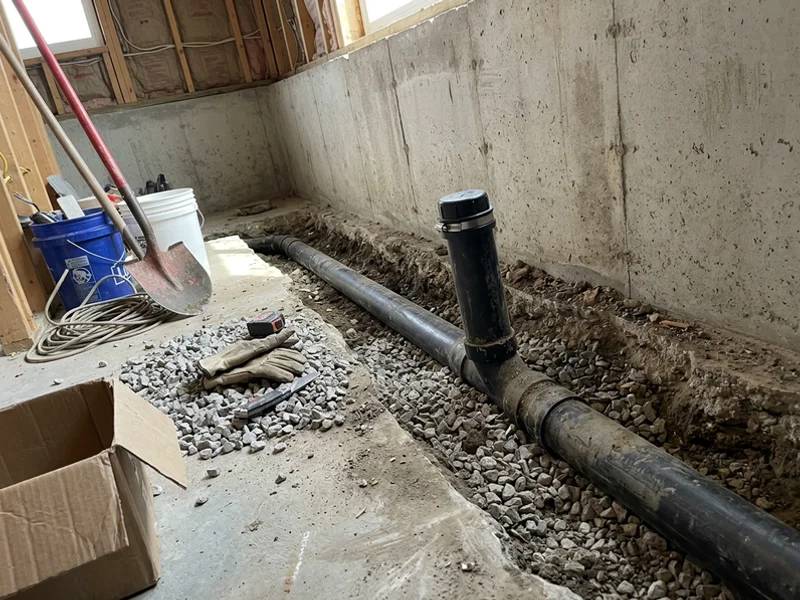 Severed and capped foundation drain beside the sanitary line